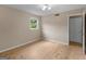 Bright bedroom with light wood floors and natural light from a window at 778 Leguin Mill Rd, Locust Grove, GA 30248