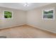 Empty bedroom showcasing natural light from two windows and wood floors at 778 Leguin Mill Rd, Locust Grove, GA 30248