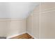 Walk-in closet with white shelving, neutral walls, and wood-look flooring at 778 Leguin Mill Rd, Locust Grove, GA 30248