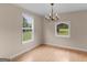 Cozy dining room featuring wood floors, a classic chandelier, and natural light for comfortable Gathering meals at 778 Leguin Mill Rd, Locust Grove, GA 30248