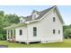 This side view features light gray siding, a gray roof, and a covered porch, nestled on a well-maintained lawn at 778 Leguin Mill Rd, Locust Grove, GA 30248