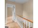 Hallway with wood floors, leading to bedroom with white trim and neutral walls at 778 Leguin Mill Rd, Locust Grove, GA 30248