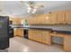 Well-lit kitchen with wooden cabinetry, tile floors and modern appliances at 778 Leguin Mill Rd, Locust Grove, GA 30248