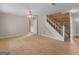 Inviting living room with hardwood floors, a ceiling fan, an open staircase, and access to other rooms at 778 Leguin Mill Rd, Locust Grove, GA 30248