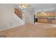 Spacious living room with hardwood floors, a classic ceiling fan, and an open staircase, perfect for Gathering gatherings at 778 Leguin Mill Rd, Locust Grove, GA 30248