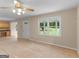 Open living area with wood floors, a ceiling fan, and a view to the home's yard through bright windows at 778 Leguin Mill Rd, Locust Grove, GA 30248