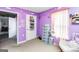 bedroom with gray dresser, purple walls, and closet storage at 1147 Dunivin Dr, Jonesboro, GA 30238