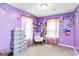 Playful bedroom featuring purple walls, whimsical decor, and ample storage at 1147 Dunivin Dr, Jonesboro, GA 30238