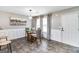 Bright dining room with a round glass table, pendant lighting, and neutral decor at 1147 Dunivin Dr, Jonesboro, GA 30238