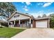 Inviting home with a brick facade, attached garage, and a cozy front porch at 1147 Dunivin Dr, Jonesboro, GA 30238