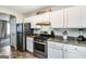 Well-lit kitchen with stainless steel appliances and ample cabinet space at 1147 Dunivin Dr, Jonesboro, GA 30238