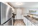 Efficient kitchen layout with stainless steel appliances and white cabinetry at 1147 Dunivin Dr, Jonesboro, GA 30238
