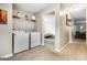 Bright laundry room with modern washer and dryer, and shelving for organized storage at 1147 Dunivin Dr, Jonesboro, GA 30238