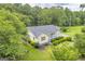 Charming one story home featuring a covered front porch and well-manicured landscaping, surrounded by mature trees at 3100 Meadow Trl, Loganville, GA 30052