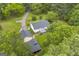 Aerial view showcasing the house, detached garage, and lush greenery surrounding the property at 3100 Meadow Trl, Loganville, GA 30052