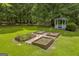 Serene backyard featuring a gazebo and raised garden beds, perfect for gardening enthusiasts at 3100 Meadow Trl, Loganville, GA 30052