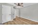 Bedroom with wood-look flooring, ceiling fan, a closet door, and natural light at 3100 Meadow Trl, Loganville, GA 30052