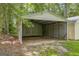 Spacious carport providing covered parking and additional storage solutions on the property at 3100 Meadow Trl, Loganville, GA 30052