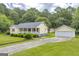 Charming one-story home with a detached garage, well-maintained landscaping, and ample yard space at 3100 Meadow Trl, Loganville, GA 30052