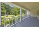 Relaxing covered front porch showcasing peaceful views of the spacious, tree-lined front yard at 3100 Meadow Trl, Loganville, GA 30052