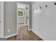 Hallway features wood-look flooring and stylish white shiplap walls with convenient coat hooks at 3100 Meadow Trl, Loganville, GA 30052