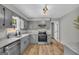 Updated kitchen with stainless steel appliances, granite countertops, and modern gray cabinetry at 3100 Meadow Trl, Loganville, GA 30052