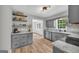 Stylish eat-in kitchen with modern gray cabinets, granite countertops, and stainless steel appliances at 3100 Meadow Trl, Loganville, GA 30052
