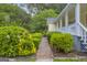 Close up of mature landscaping, a brick path, and the side of the home at 3100 Meadow Trl, Loganville, GA 30052