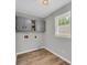 Bright laundry room features sleek gray cabinets and flooring, with a large window for natural light at 3100 Meadow Trl, Loganville, GA 30052