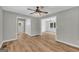 Open-concept living room with wood-look floors and views into the kitchen and hallway at 3100 Meadow Trl, Loganville, GA 30052
