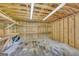 Interior view of the shed featuring wooden walls, peg board, overhead lighting and shelves at 3100 Meadow Trl, Loganville, GA 30052