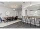 Charming dining area with a long wooden table, contemporary chairs, and a modern kitchen in the background at 276 Oliver Dr, Locust Grove, GA 30248