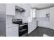 Bright kitchen with stainless steel appliances, white cabinets, and tile backsplash exudes a clean, modern aesthetic at 276 Oliver Dr, Locust Grove, GA 30248