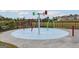 Community splash pad with colorful features and a spacious play area for outdoor fun on a sunny day at 276 Oliver Dr, Locust Grove, GA 30248