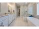 Elegant bathroom features dual vanities, marble floors, and a spacious glass shower with a modern soaking tub at 3076 East Lake Rd, Mcdonough, GA 30252