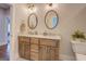 Elegant bathroom featuring a double vanity, granite countertops, and framed mirrors at 3076 East Lake Rd, Mcdonough, GA 30252