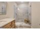 Modern bathroom with granite countertop, modern glass shower with a built-in bench and gray accent tile at 3076 East Lake Rd, Mcdonough, GA 30252