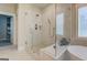 Modern bathroom features a glass shower, marble tile, and a built-in bench with luxurious gray towels at 3076 East Lake Rd, Mcdonough, GA 30252