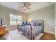 Cozy bedroom with an iron bed frame, blue accents, a ceiling fan and hardwood floors at 3076 East Lake Rd, Mcdonough, GA 30252