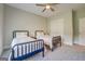 Cozy bedroom with two twin beds, ceiling fan, and closet for ample storage space at 3076 East Lake Rd, Mcdonough, GA 30252