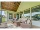 Spacious covered porch with comfortable seating, perfect for enjoying the views and outdoor living at 3076 East Lake Rd, Mcdonough, GA 30252