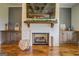 Close up of brick fireplace with a decorative wood mantel and wood storage cabinets at 3076 East Lake Rd, Mcdonough, GA 30252