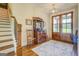 Inviting foyer with wooden staircase, antique furnishings, and decorative rug, creating a warm welcome at 3076 East Lake Rd, Mcdonough, GA 30252