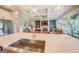 Bright, open kitchen featuring a large island with a sink, quartz countertops, and views into the living room at 3076 East Lake Rd, Mcdonough, GA 30252
