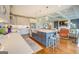 Spacious kitchen with an island and seating, stainless appliances, and opening into the living room at 3076 East Lake Rd, Mcdonough, GA 30252
