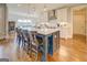 Spacious kitchen with an oversized island, pendant lighting, stainless steel appliances, and hardwood flooring at 3076 East Lake Rd, Mcdonough, GA 30252