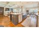 Open kitchen with a large island, stainless steel appliances, hardwood floors, and an open floorplan at 3076 East Lake Rd, Mcdonough, GA 30252