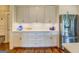 Bright kitchen with white cabinetry, stainless steel refrigerator, and hardwood flooring at 3076 East Lake Rd, Mcdonough, GA 30252