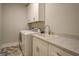 Functional laundry room with modern appliances, countertop space, and overhead storage at 3076 East Lake Rd, Mcdonough, GA 30252