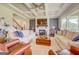 Spacious living room with a white brick fireplace, coffered ceilings and large windows at 3076 East Lake Rd, Mcdonough, GA 30252